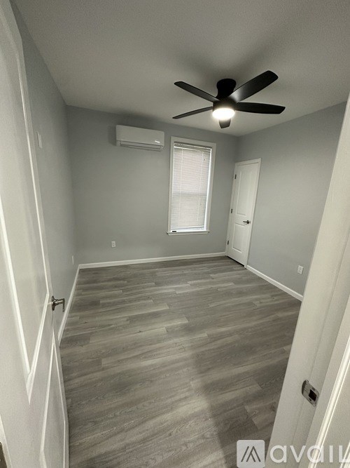 A room with a ceiling fan and a window.