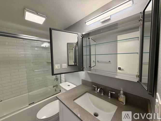 A bathroom with a sink, toilet, and bathtub.