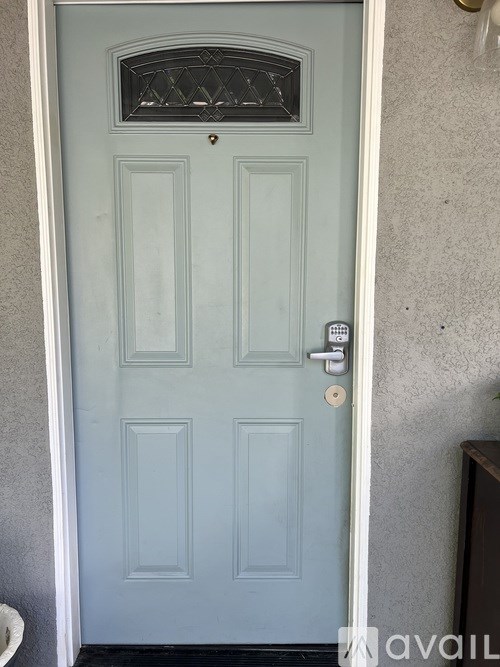 A blue door with a glass window above the main door.