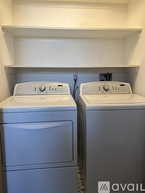 Two front loading washing machines in a laundry room.