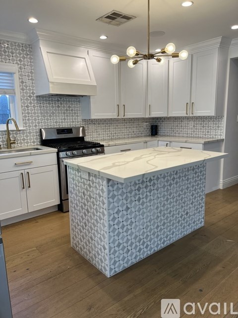 A kitchen with a patterned island in the middle.
