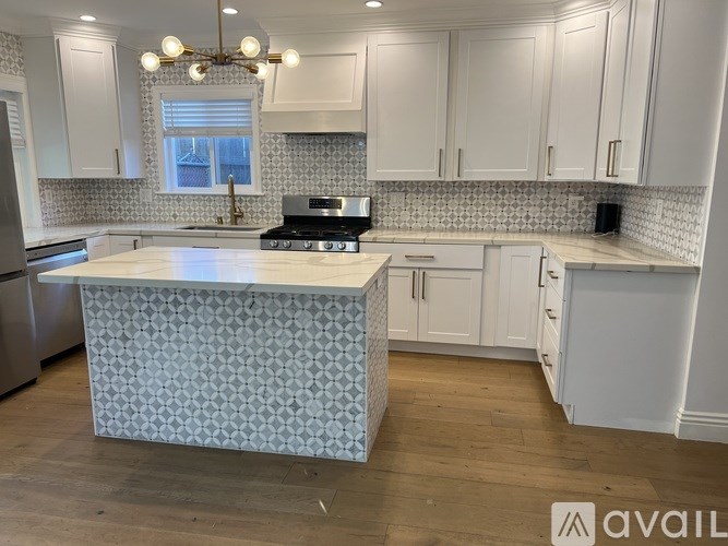 A kitchen with a patterned island in the middle.