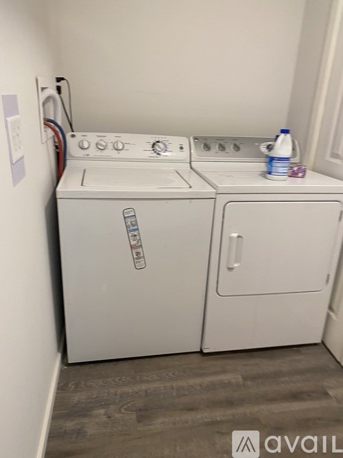 A white washing machine and dryer in a small laundry room.