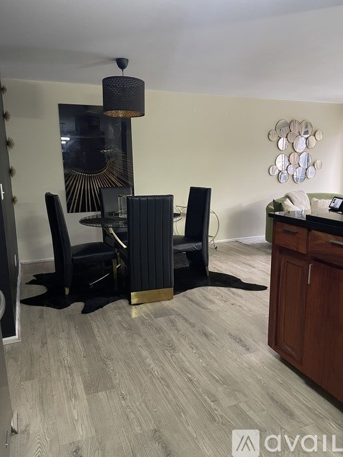 A dining room with a black and gold table set.