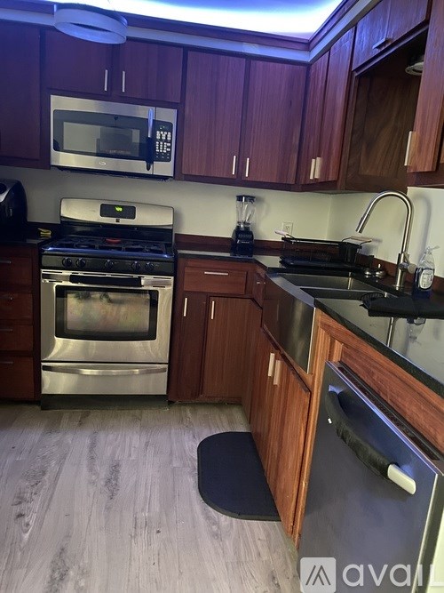 A kitchen with wooden cabinets and stainless steel appliances.
