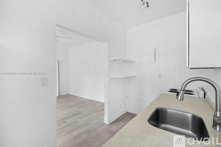 A kitchen with a sink and a countertop.