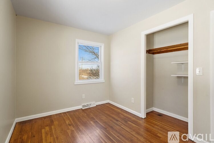 A room with a wooden floor and a window.