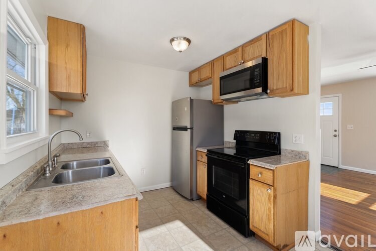 A kitchen with wooden cabinets and a black oven.