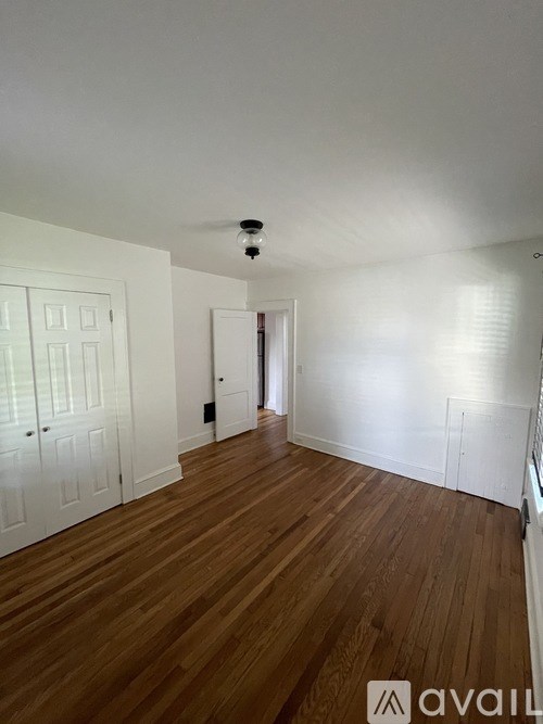 A room with wooden floors and white walls.