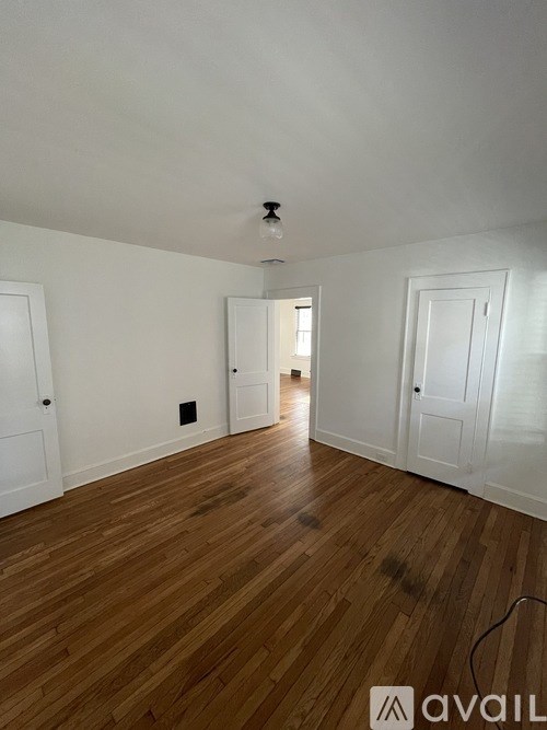 A room with wooden floors and white walls.