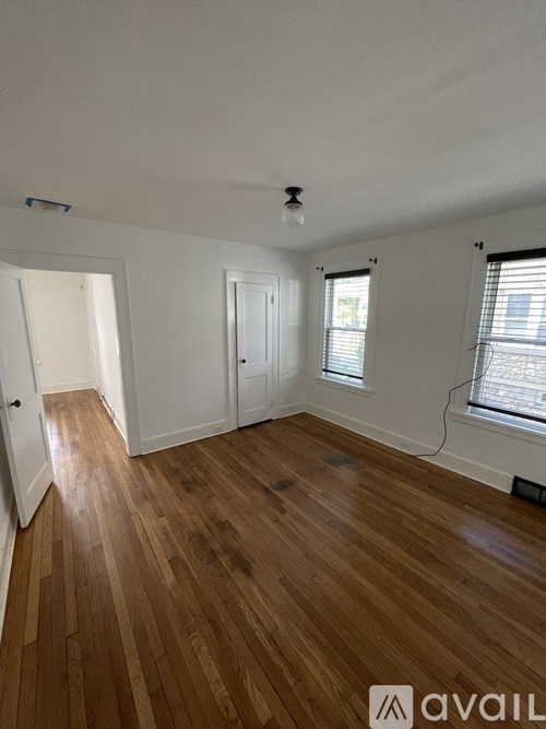 A room with wooden floors and white walls.
