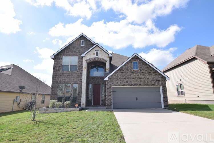 A house with a red door and a garage is for sale.
