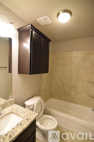 A bathroom with a toilet, sink, and bathtub.