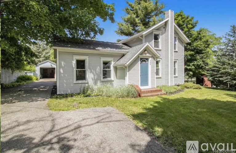 A house with a blue door is for sale.