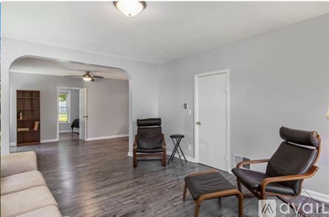 A living room with a chair and a sofa.