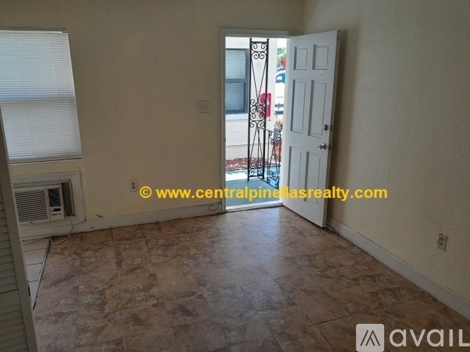 A room with a tiled floor and a door leading outside.