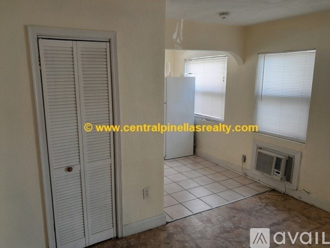 A room with a door, a window, and a tiled floor.