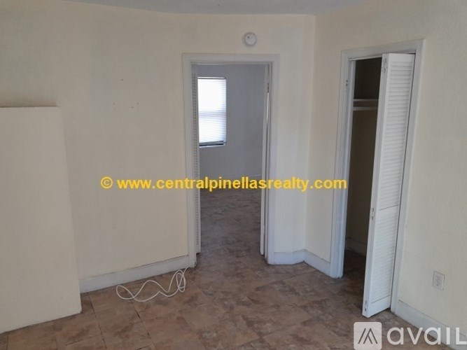 A room with a doorway leading to another room and a window.