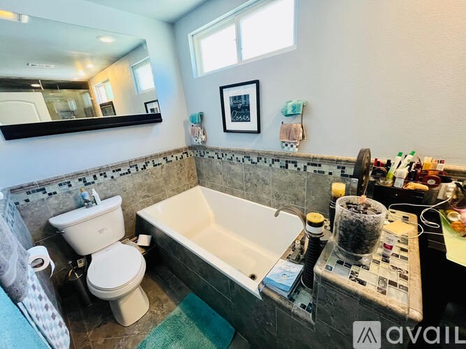 A bathroom with a toilet, sink, and bathtub.