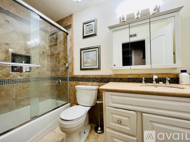 A bathroom with a toilet, sink, and shower.