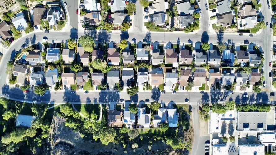 A bird's eye view of a residential neighborhood with houses and streets.
