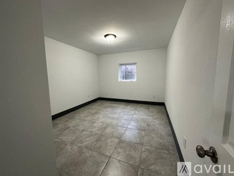 A room with tiled flooring and a window.