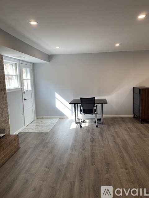 A room with a desk and a chair in it.