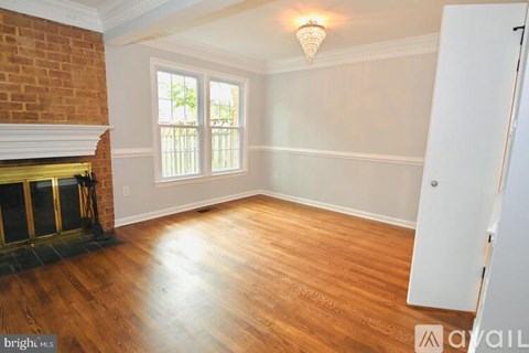 A room with a fireplace and a window.