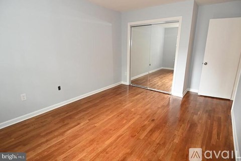 A room with wooden floors and a sliding glass door.