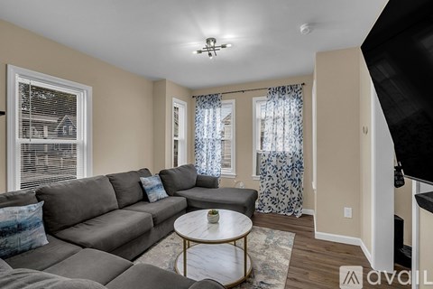 A living room with a grey couch and a coffee table.