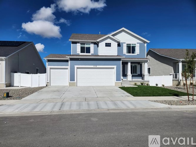 A modern two-story house with a garage is available for sale.