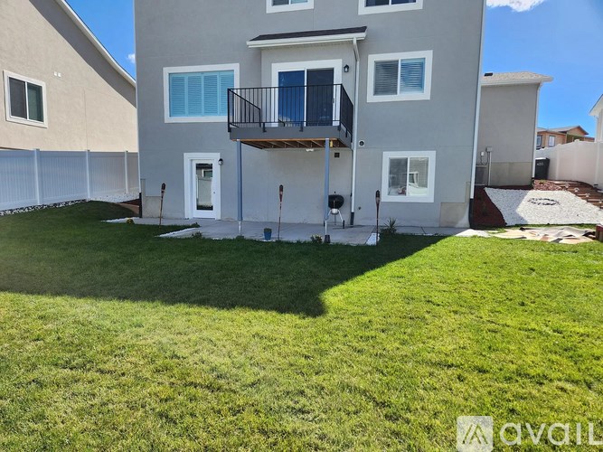 A two-story house with a balcony on the second floor.