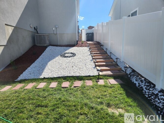 A white and black circular design is on a white gravel area.