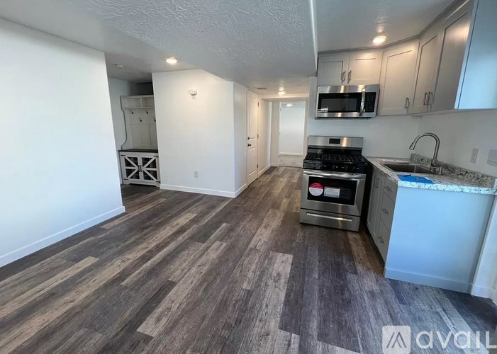 A kitchen with a stove top oven and a microwave above the stove.