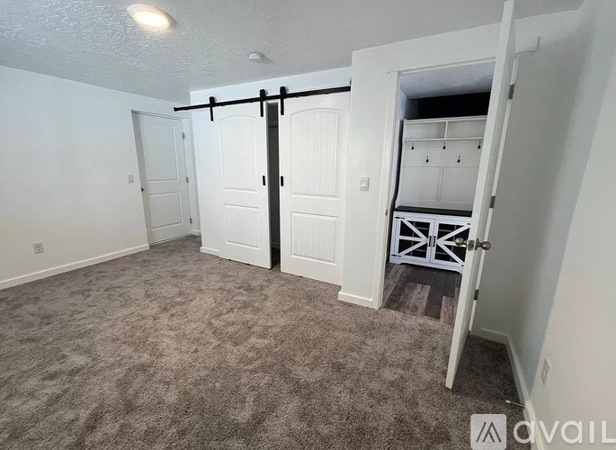 A room with a sliding door and a carpeted floor.