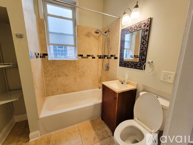 A bathroom with a tub, toilet, and sink.
