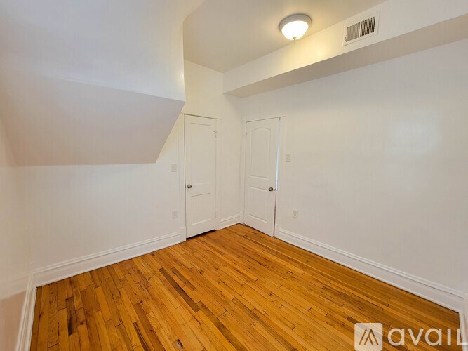 A room with wooden floors and white walls.