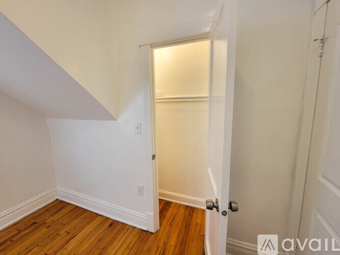 A room with a wooden floor and white walls.