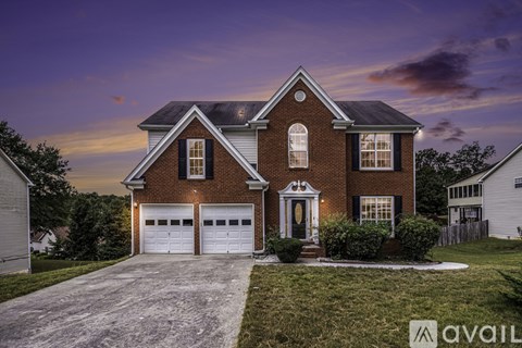 A house with a brick facade and a large front yard.