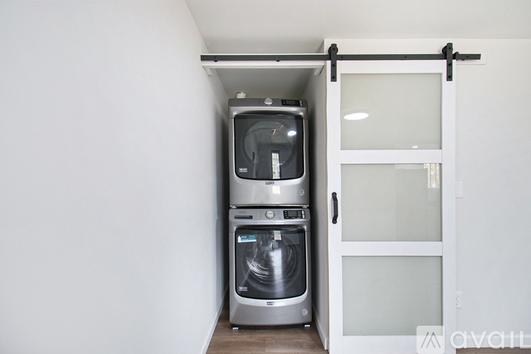 A modern kitchen with a built-in dishwasher and oven.