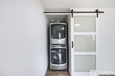 A modern kitchen with a built-in dishwasher and oven.