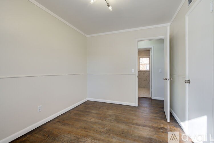 A room with wooden floors and white walls.