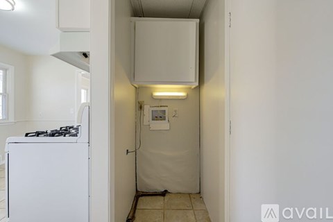 A small kitchen with a white stove and a white fridge.