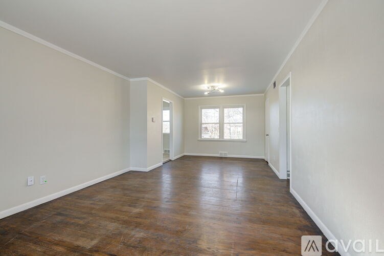 A room with wooden floors and white walls.