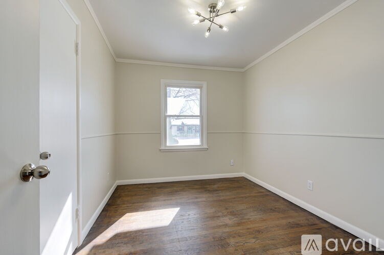 A room with a window and a door.