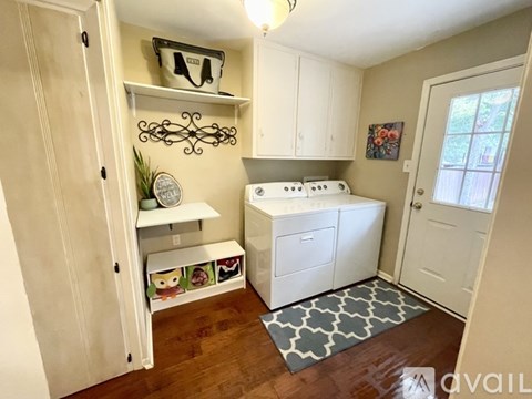 A small kitchen with a white stove top oven and white cabinets.