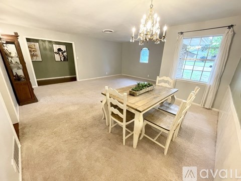 A dining room with a wooden table and chairs.