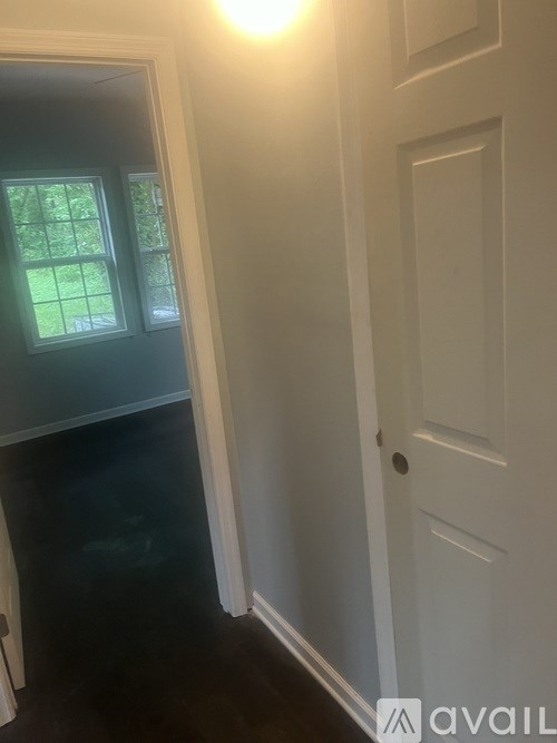 A white door with a small hole in the center.