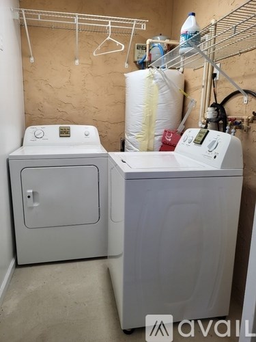 A small laundry room with a washer and dryer.