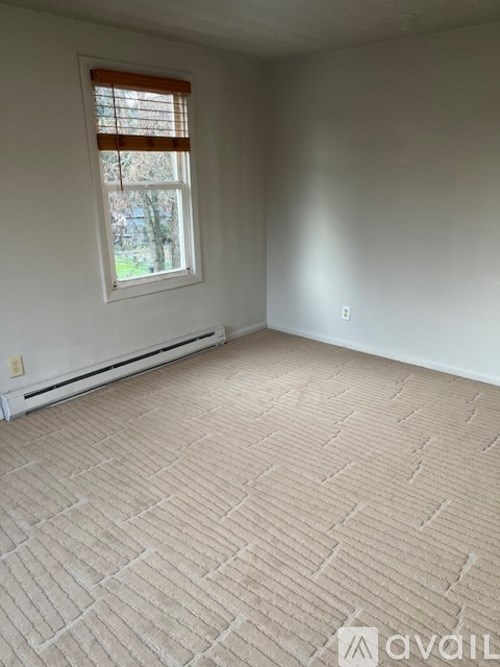 A room with a window and a tiled floor.